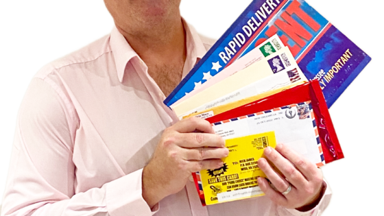Nick James Holding Direct Mail Envelopes